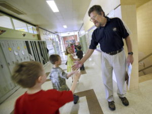 private nws kwg 2-5--Holy Angels School principal Mike Sternig gives high-fives to students as they pass him in the hallway at the West Bend school, April 24, 2009. Enrollment at Holy Angels School has declined in the past years, but not quite as sharply as nearby St. Mary's School, which has prompted the schools to begin talks about how they can find mutually beneficial options for both schools in the upcoming school year. The school has 4-year-old kindergarten through eighth grade. PHOTO: KRISTYNA WENTZ-GRAFF / KWENTZ@JOURNALSENTINEL.COM