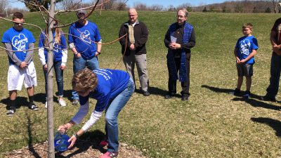 Lori Johnson watering tree for Logan