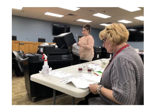 Clerk counting ballot from April 7 election