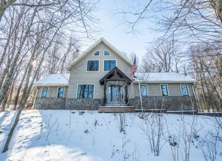 REAL ESTATE | Escape to the Woods: Lodge-style home tucked into West Bend’s snowy landscape | By Emmer Real Estate Group